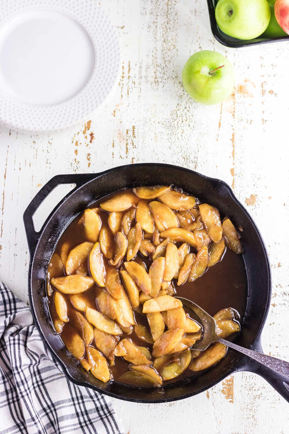 Overhead view of fried apples in a skillet.