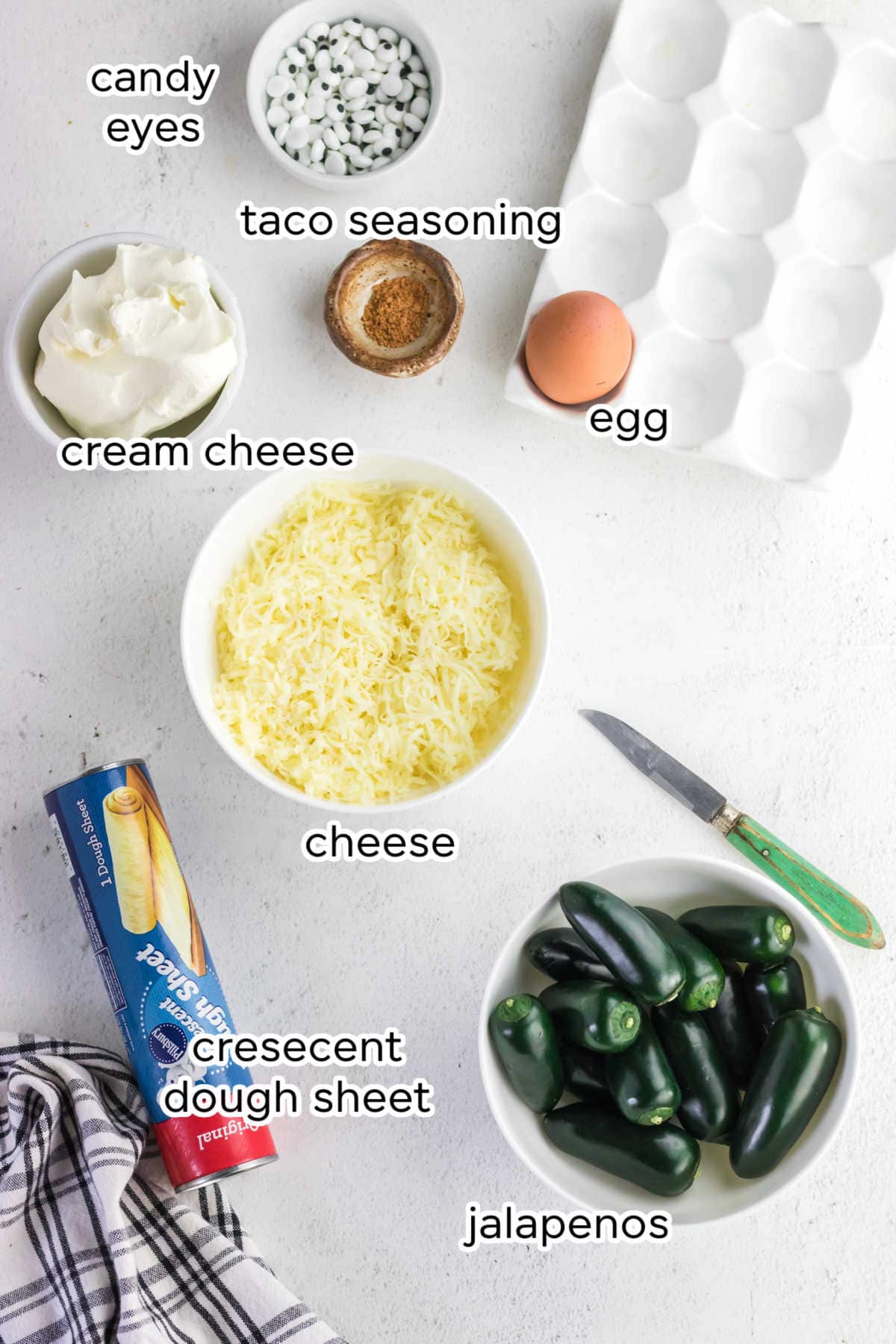 Labeled ingredients for mummy jalapeno poppers.