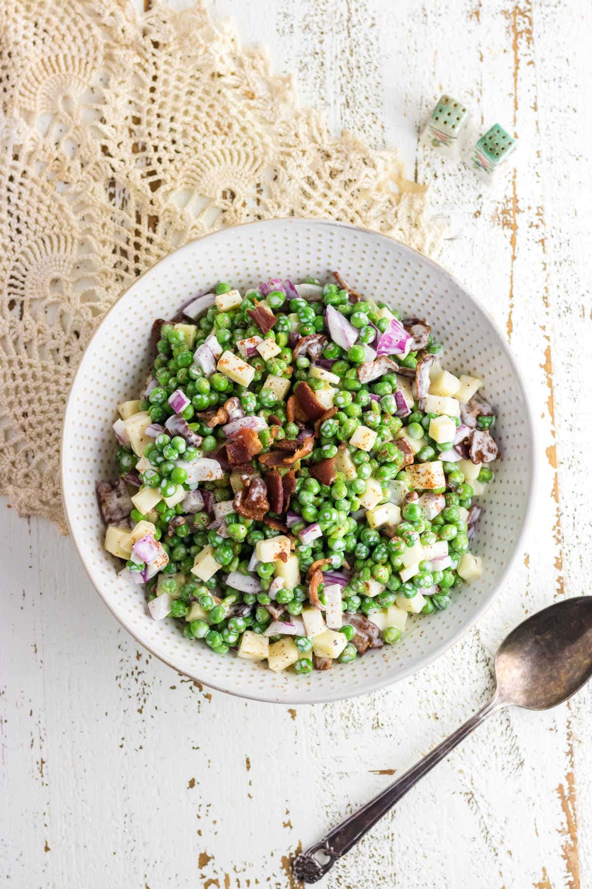 Pea salad with crispy bacon on top.