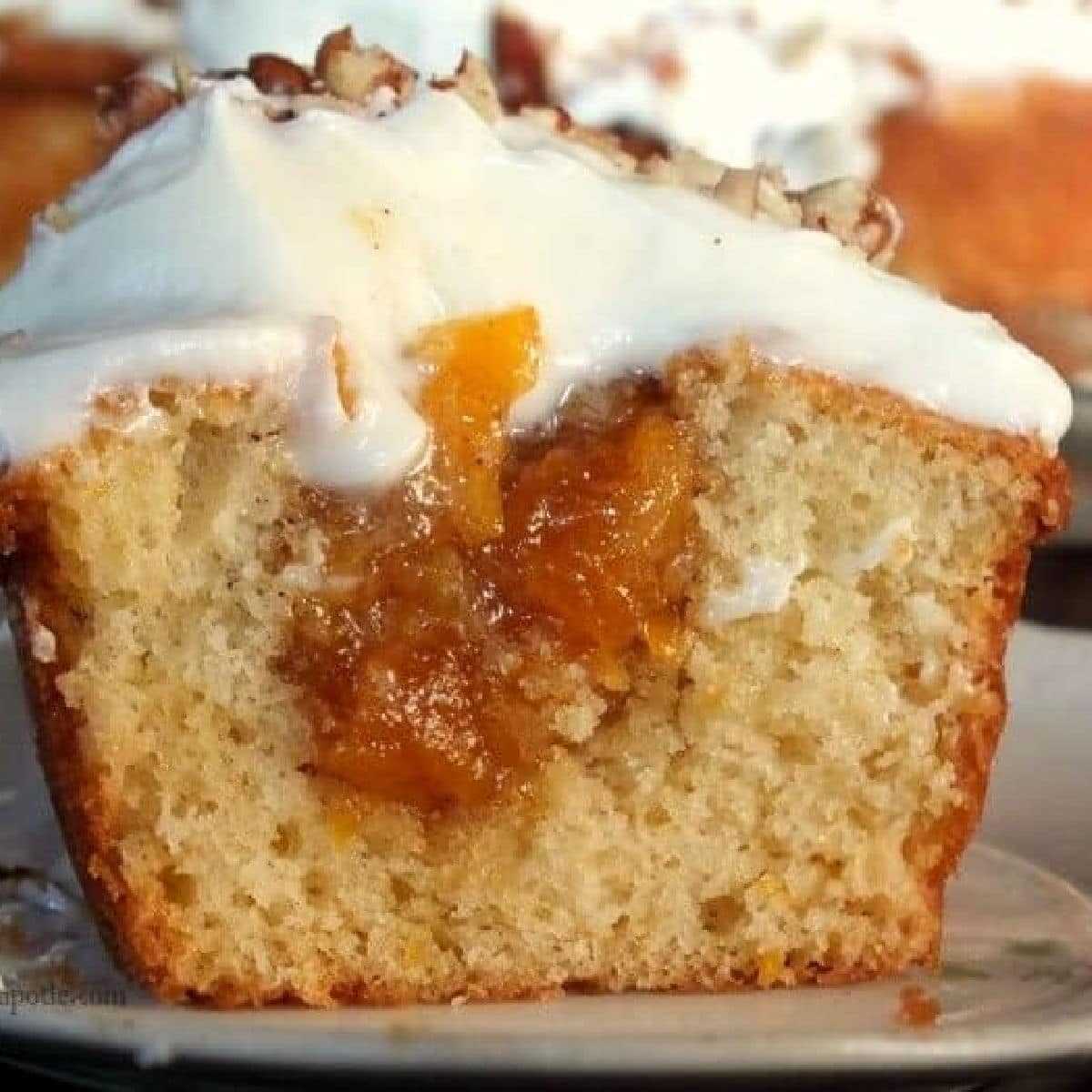 Peach cupcake cut in half to show filling.