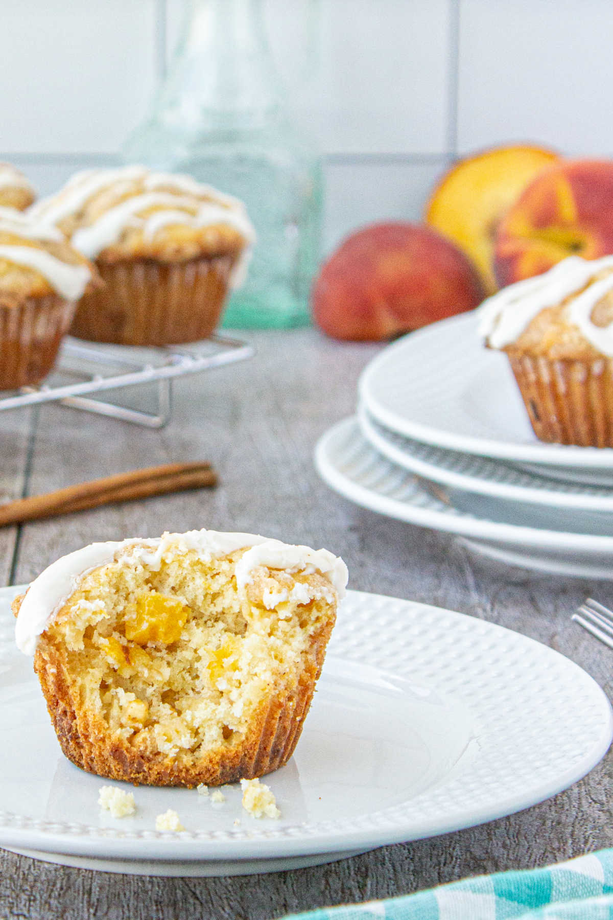 A muffin on a plate with a bite removed to show interior texture.