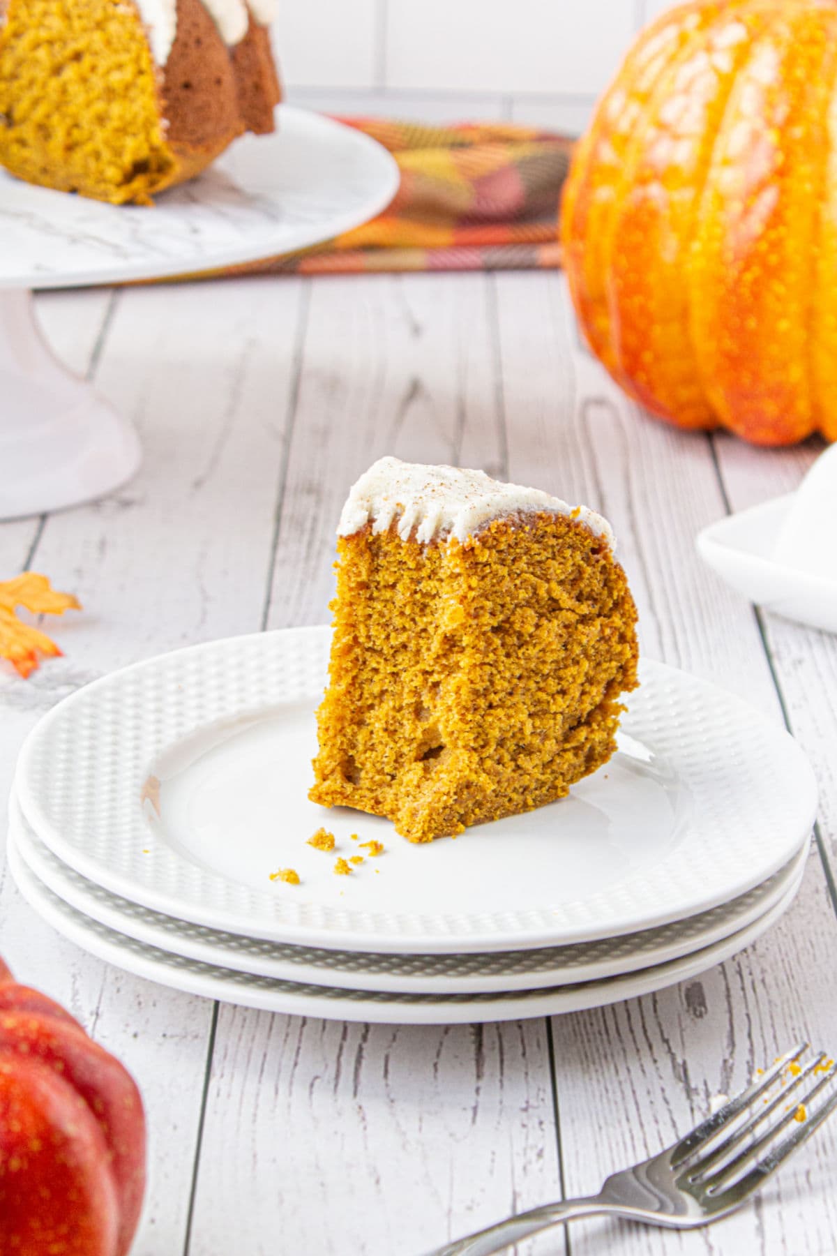 A slice of pumpkin cake on a plate.