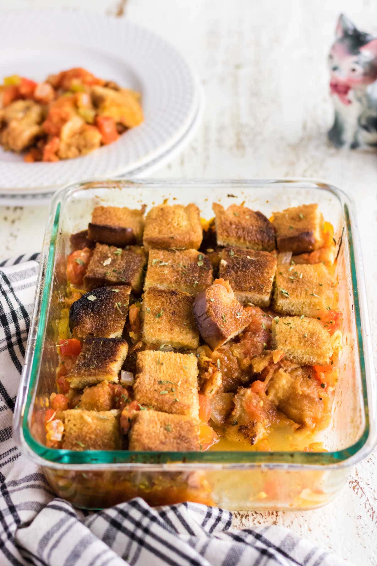 A baking dish of scalloped tomatoes on a table.