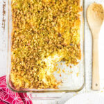 Overhead view of squash casserole with a serving removed to show the creamy interior.