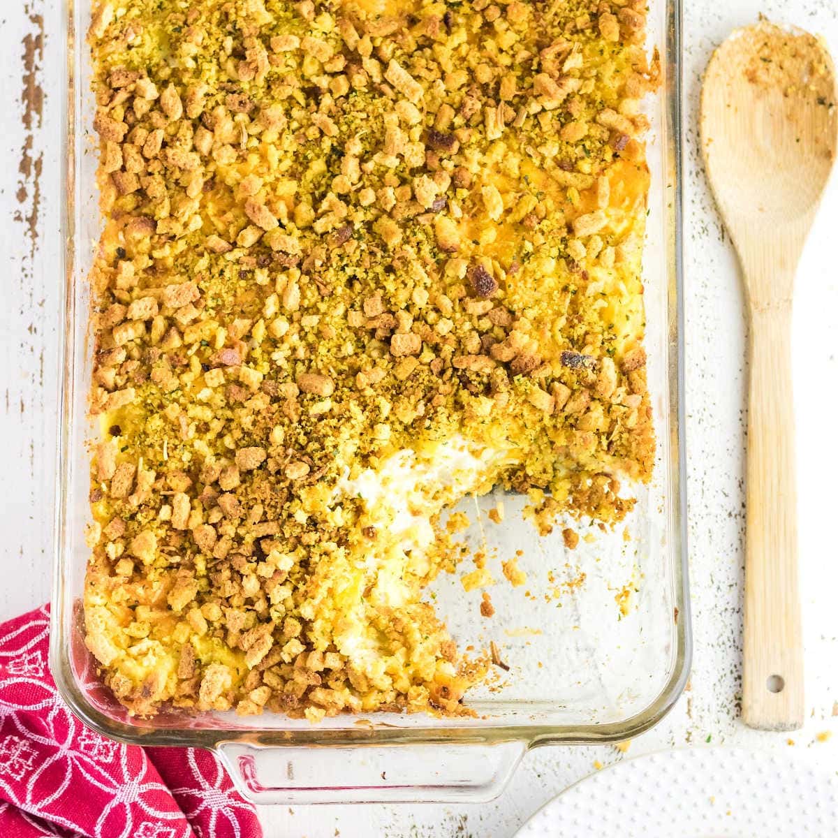 Overhead view of squash casserole with a serving removed to show the creamy interior.