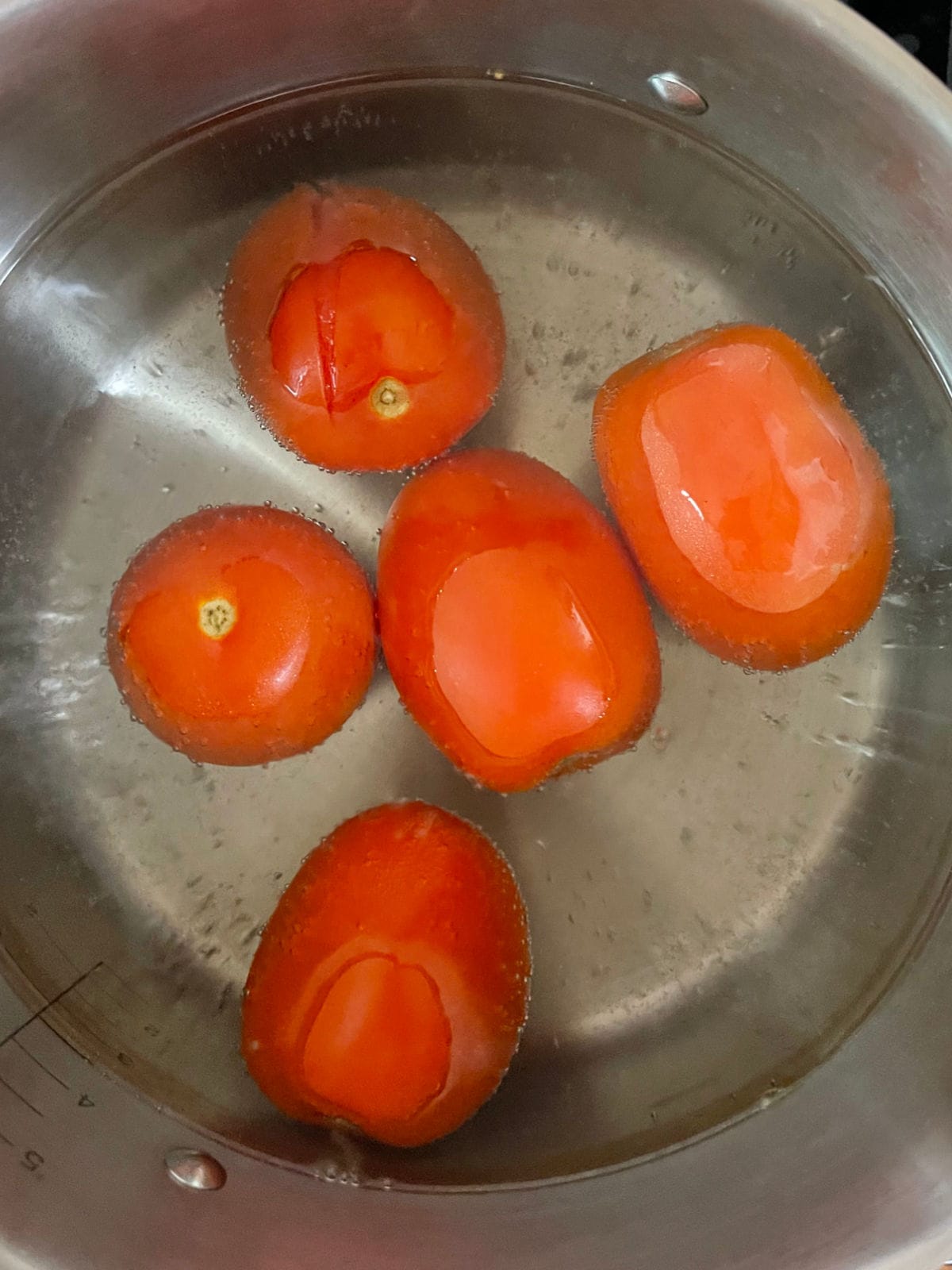 Tomatoes in simmering water.