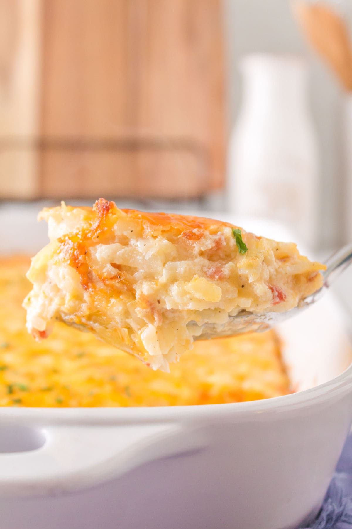 A scoop of casserole being removed from a dish.