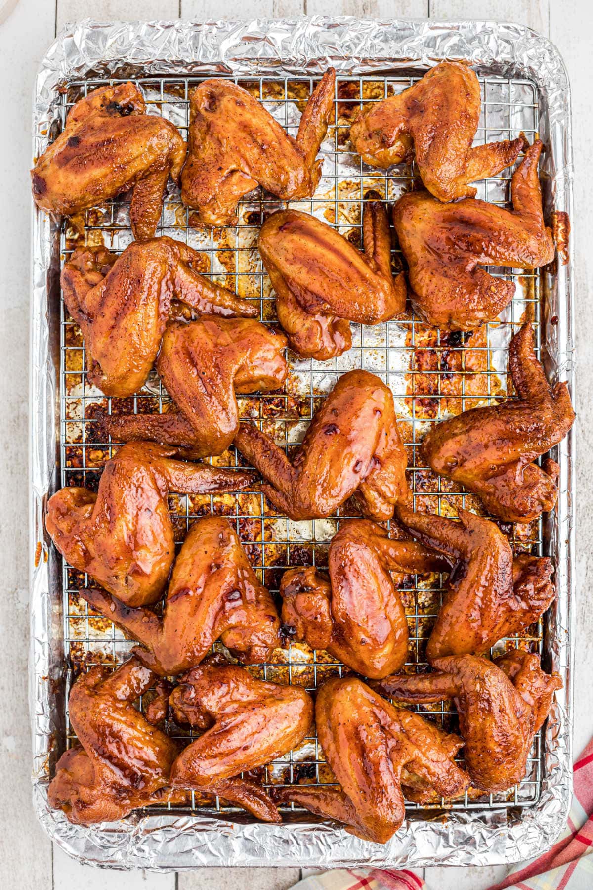 Overhead view of baked wings that have been dipped in glaze.