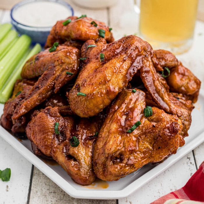 Closeup of finished glazed wings on a platter for the feature image.