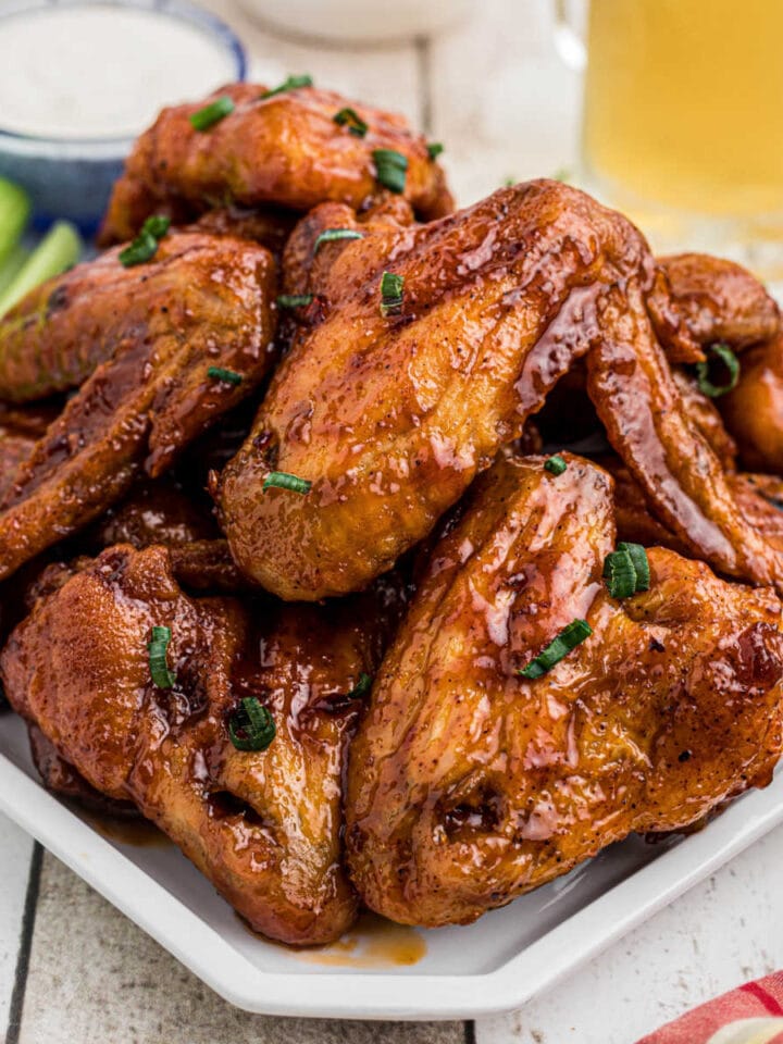 Closeup of finished glazed wings on a platter for the feature image.