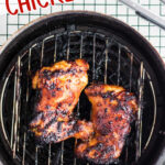 Air fried bbq chicken thighs on an air fryer with a text overlay for Pinterest.