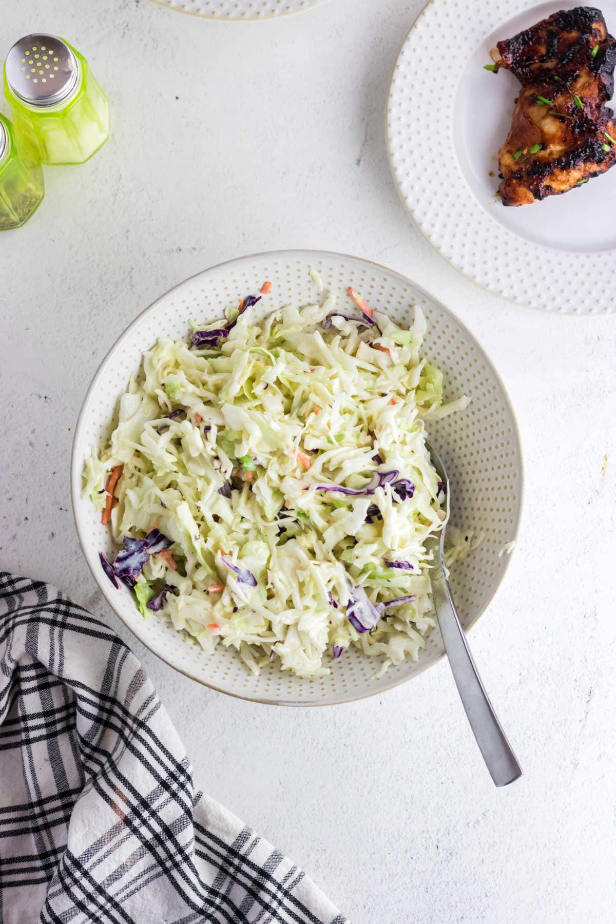 Overhead view of a bowl of coleslaw on a table.