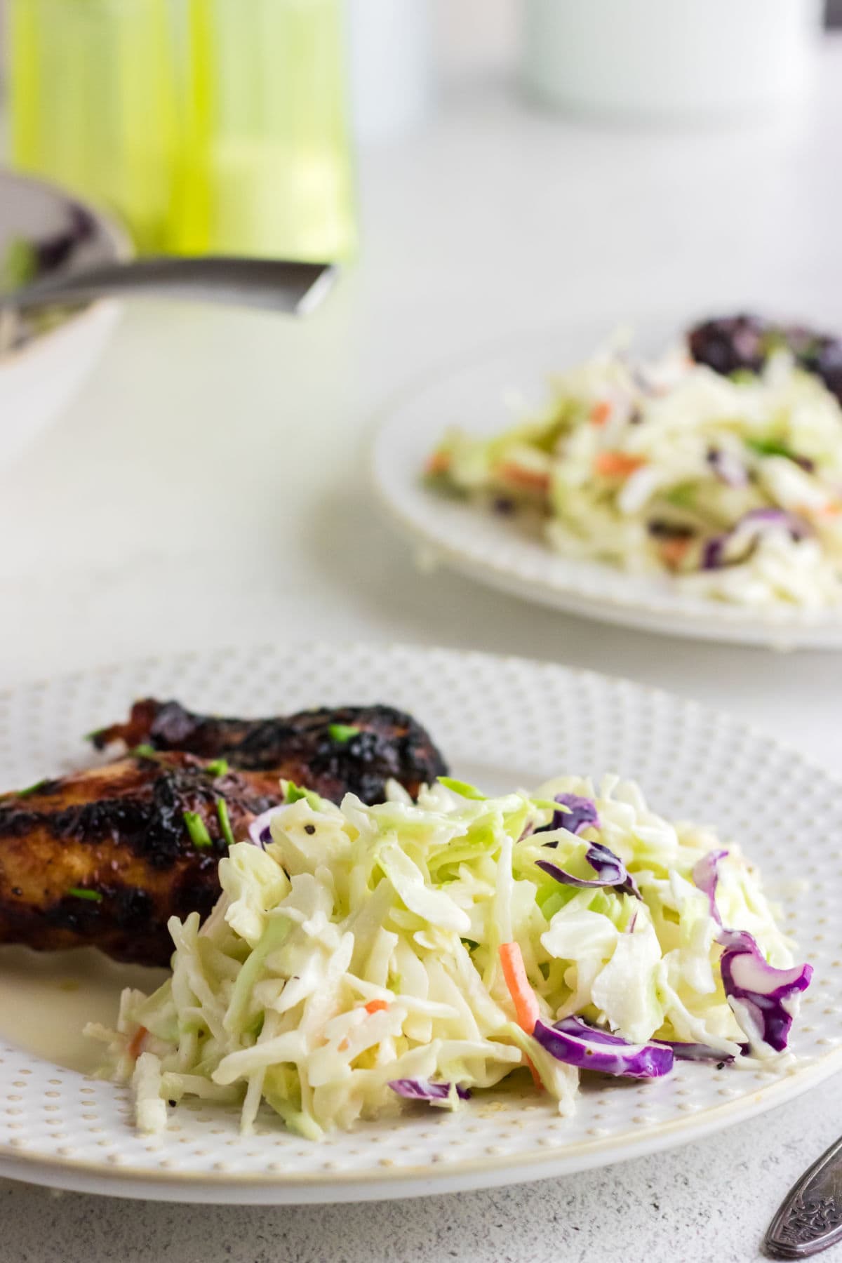 Closeup of a serving of coleslaw showing the dressing and texture.