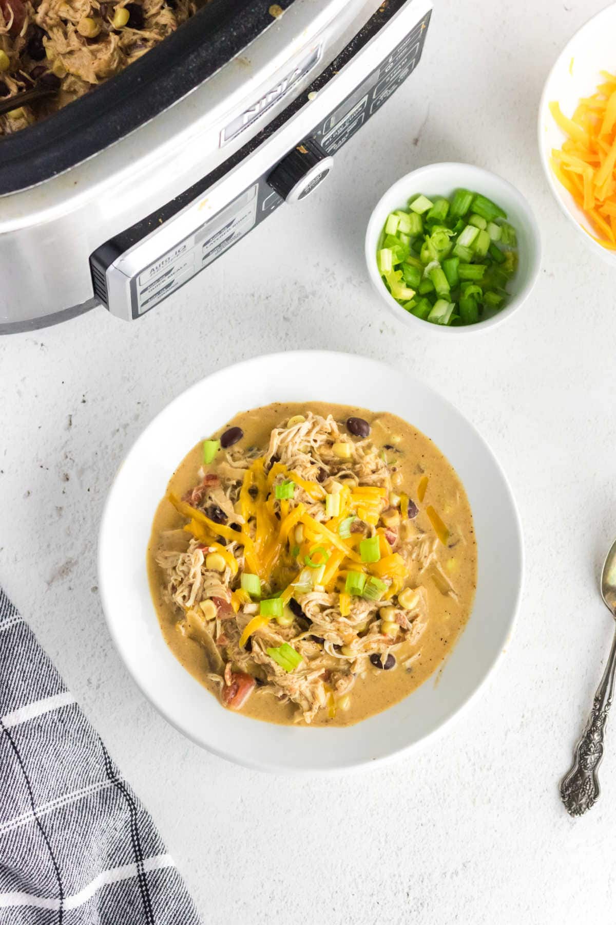 A bowl of chicken chili ready to eat.