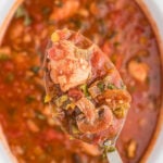 A ladle of chicken cacciatore being removed from the slow cooker with text overlay for Pinterest.