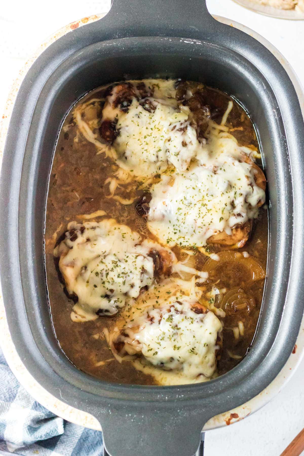 Overhead view of French onion chicken in the slow cooker.