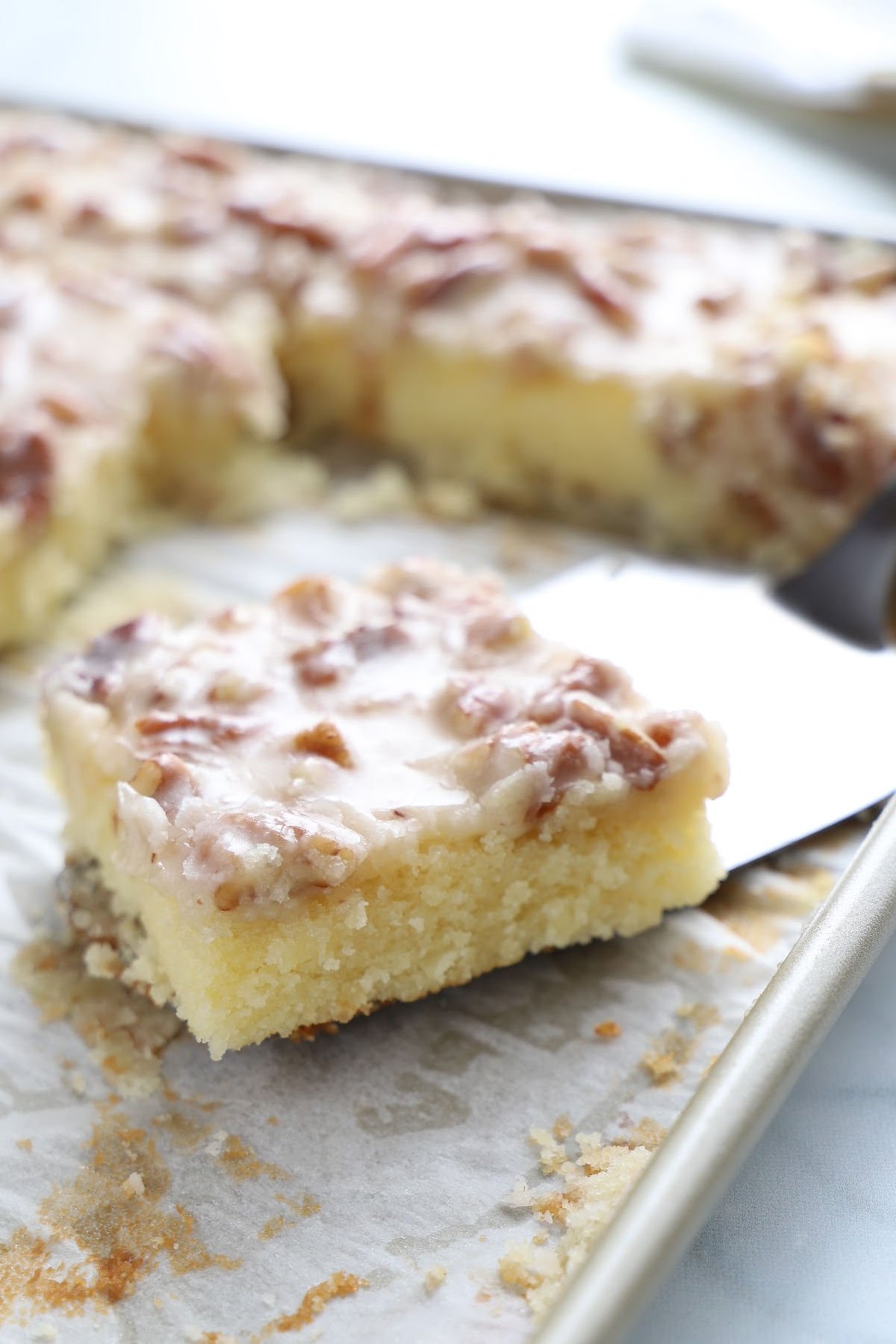 A square of white cake being served.