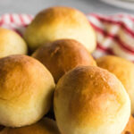 Closeup of rolls in a basket with text overlay for Pinterest.