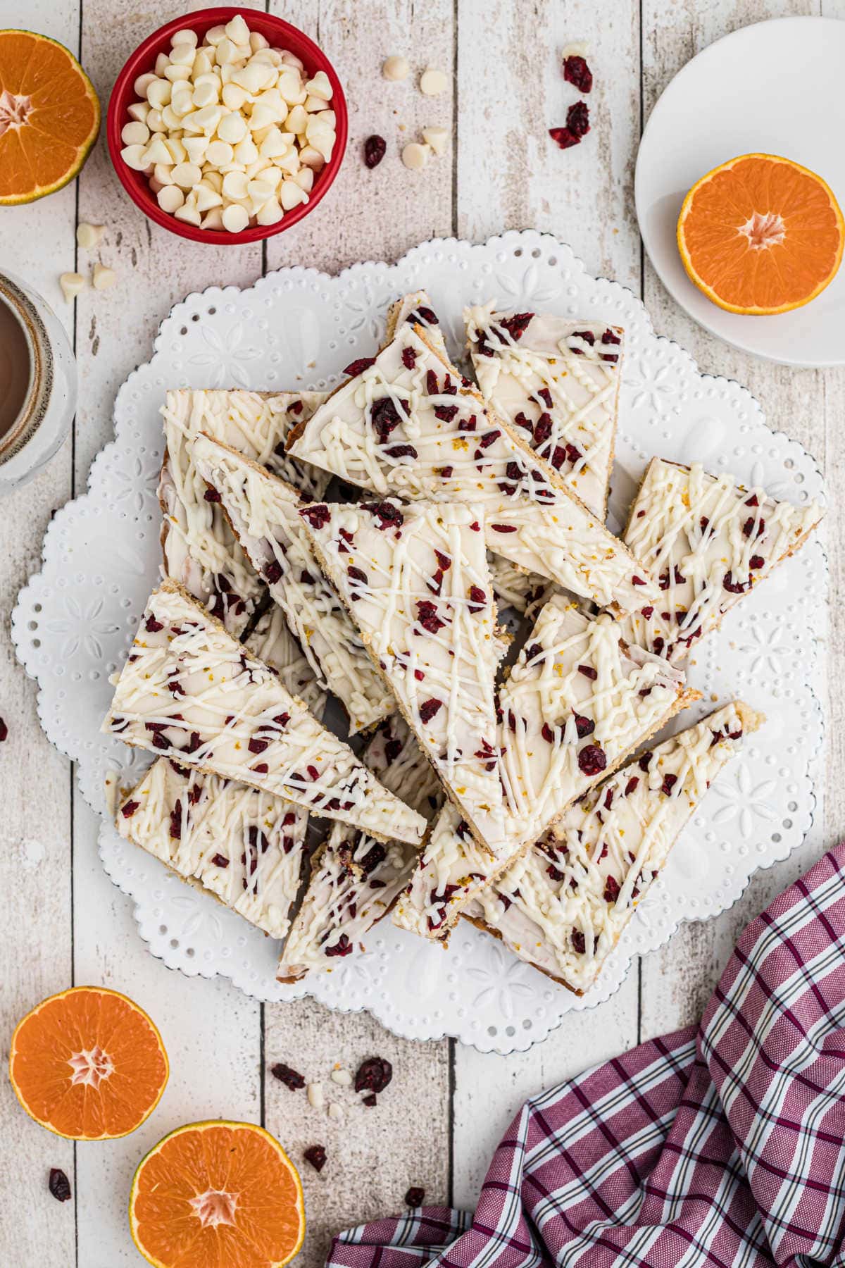 Overhead view of cranberry bliss bars stacked on white plate