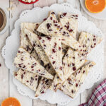 Overhead shot of cranberry bliss bars on white plate.