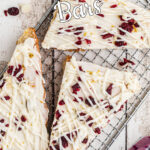 Overhead view of cranberry bliss bars with text overlay for Pinterest.