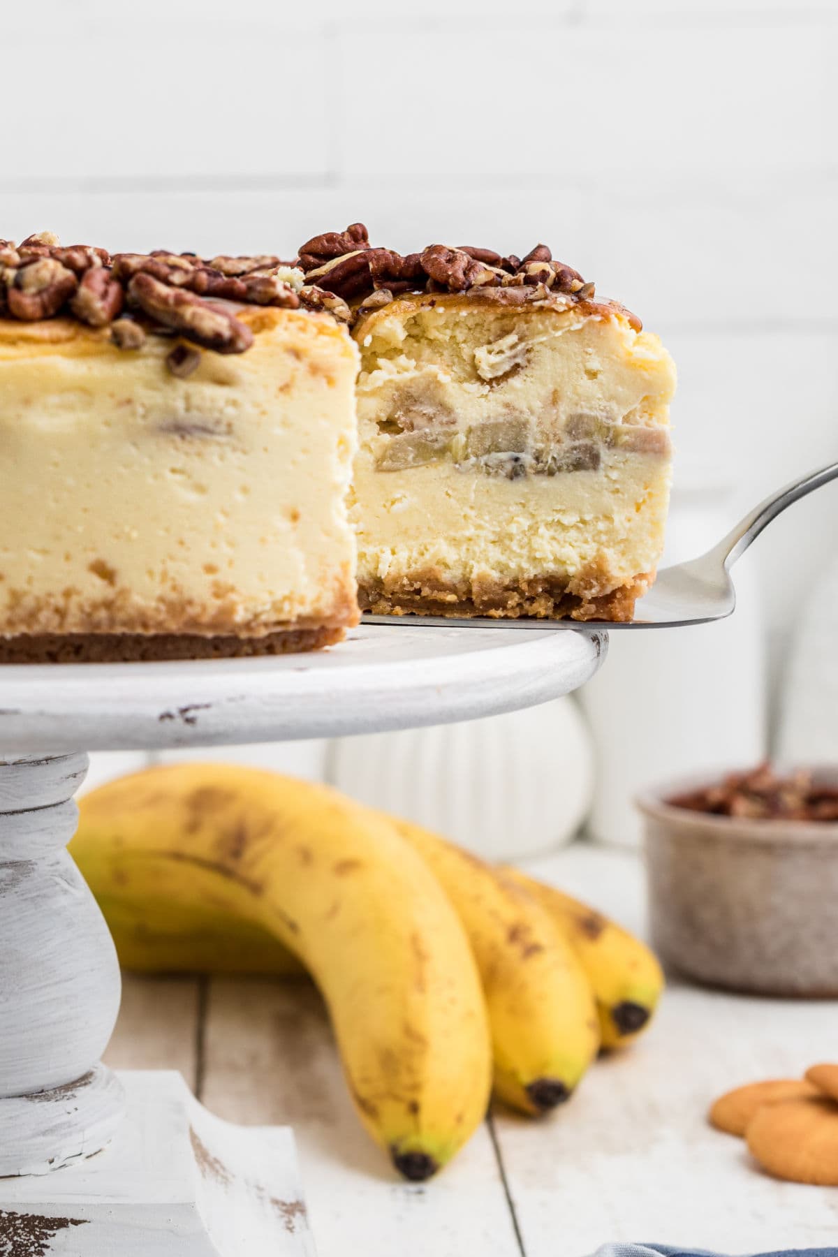 The cheesecake on a cake stand.