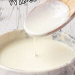 A wooden spoon with white sauce dripping off of it and a text overlay for Pinterest.