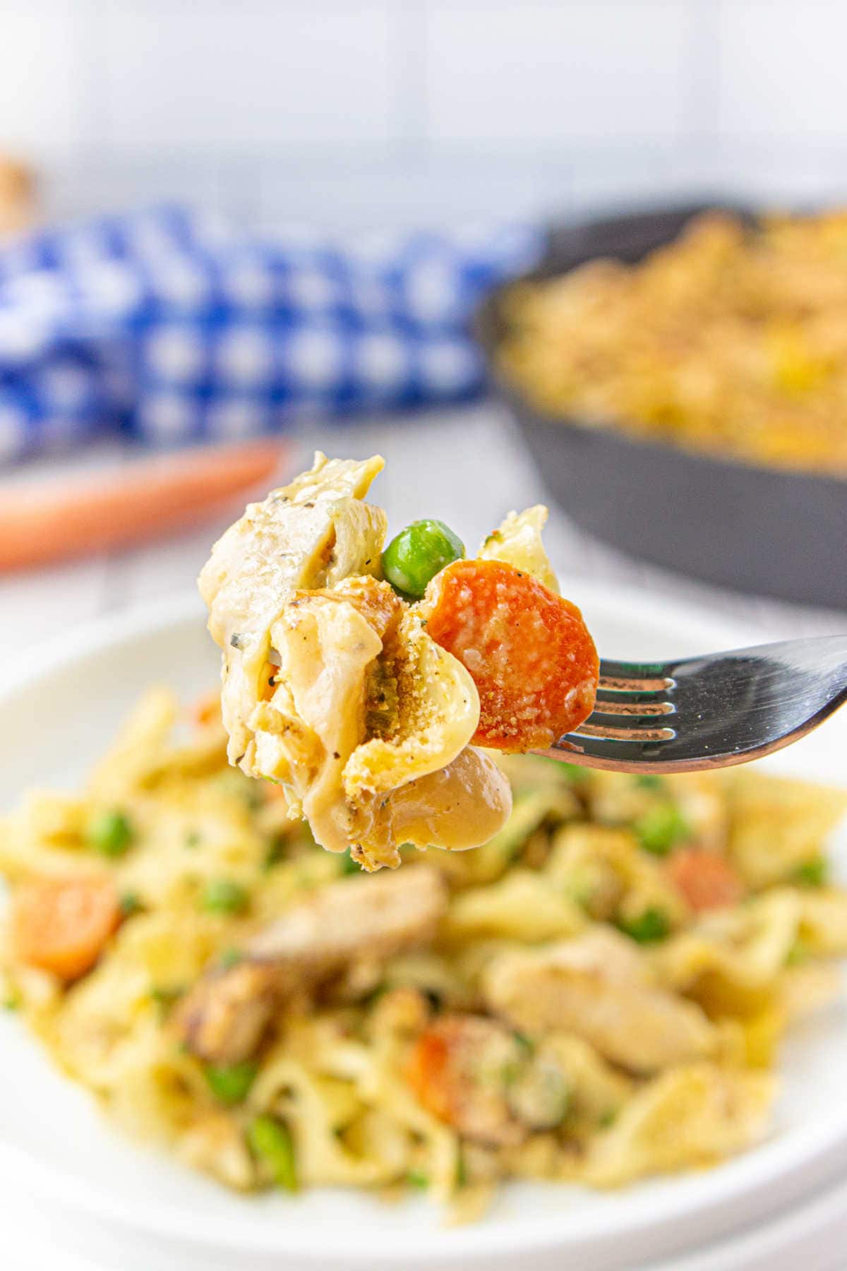 A forkful of casserole being lifted from the plate.