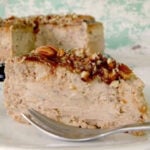 A slice of pecan praline cheesecake on a plate.