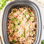 Overhead view of finished chicken in the crockpot with text overlay for Pinterest.