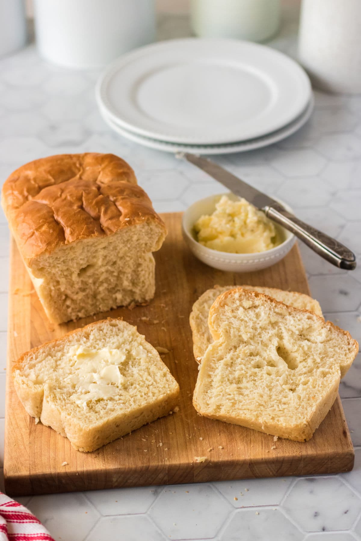 Batter bread next to slices with butter.
