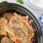 Overhead view of pork and cabbage in the crock pot with text overlay for Pinterest.