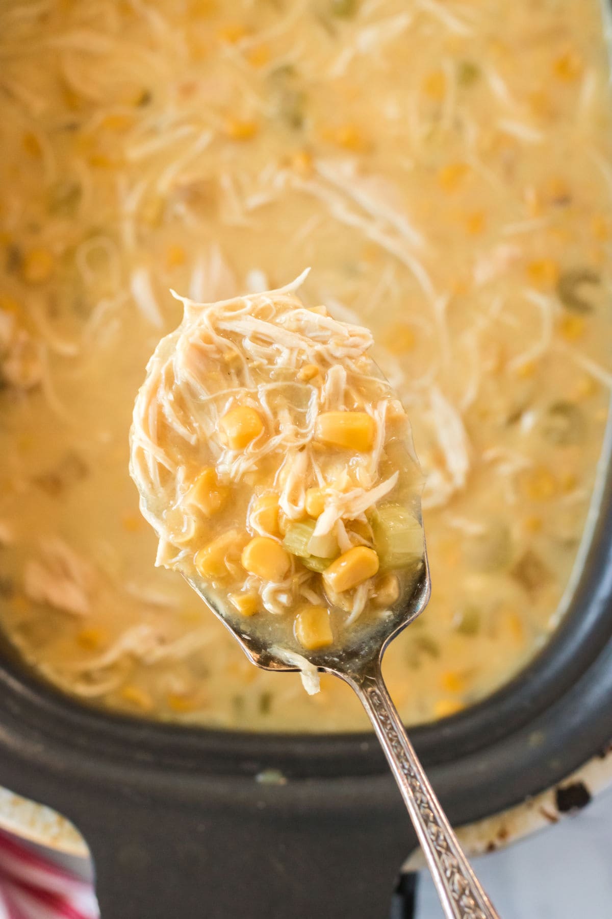 Chicken corn chowder with a spoon.