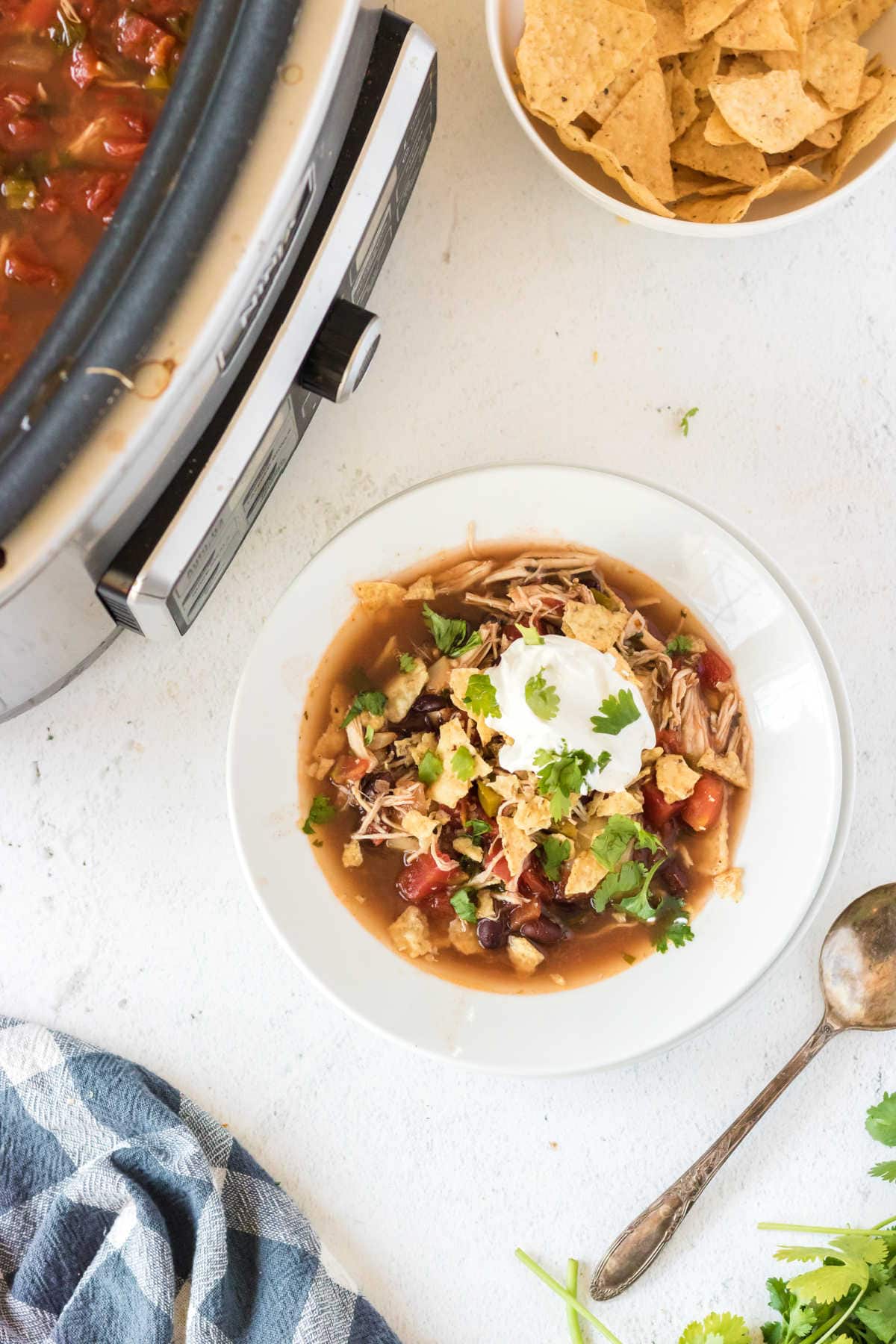 A serving of Chicken Tortilla Soup in a white bowl.