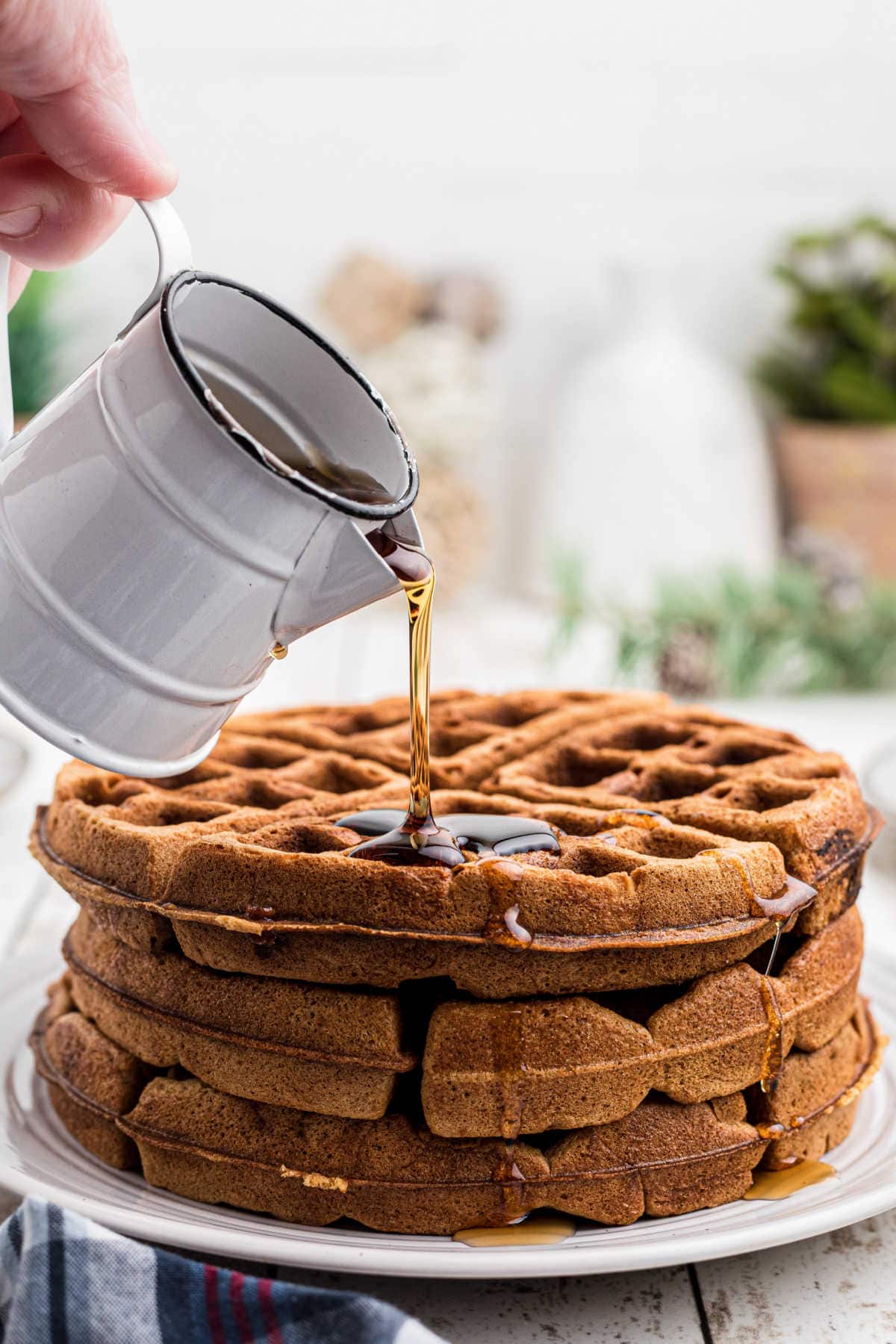 Syrup being poured on the waffles.