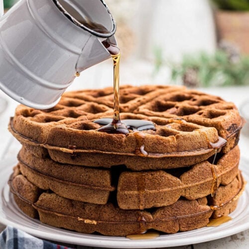 Syrup being poured on waffles for featured image.