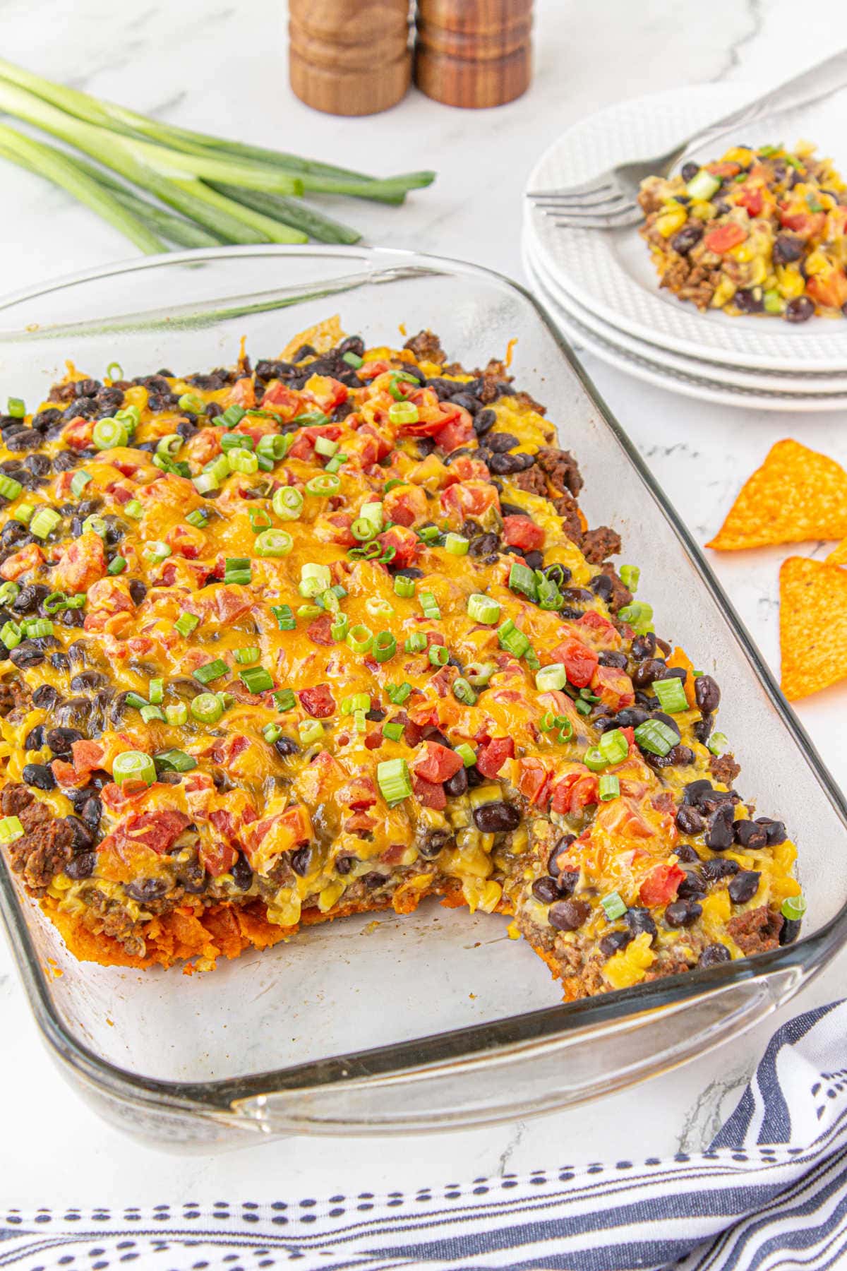 Ground beef dorito casserole with serving taken out.