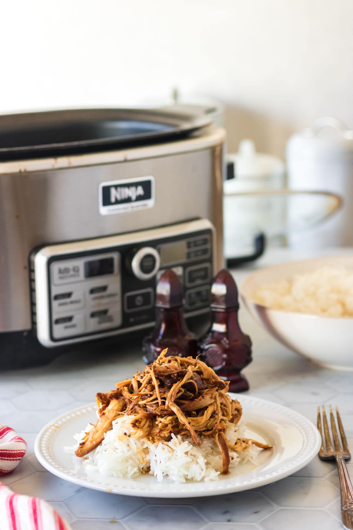 Slow cooker honey mustard chicken on a white plate.