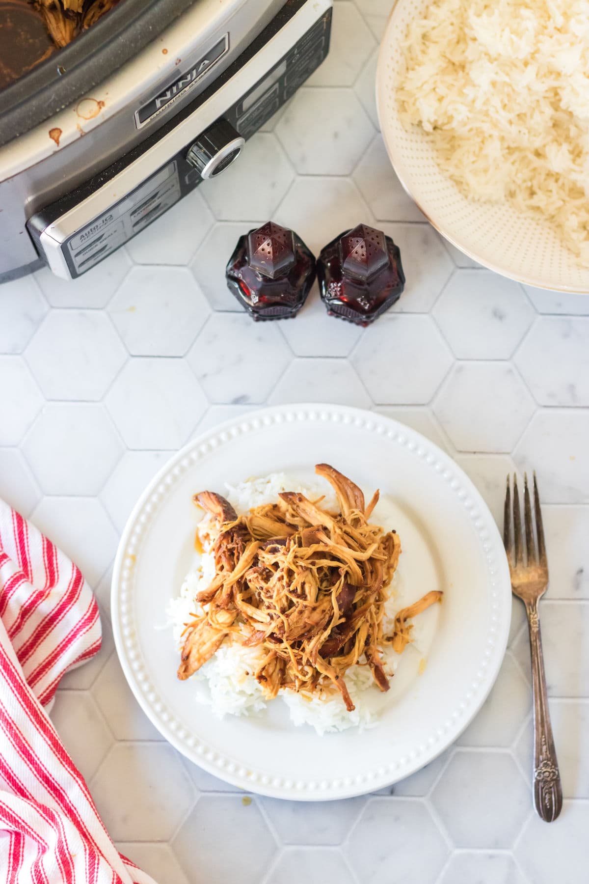 Overhead view of honey mustard chicken on a white plate with a fork.