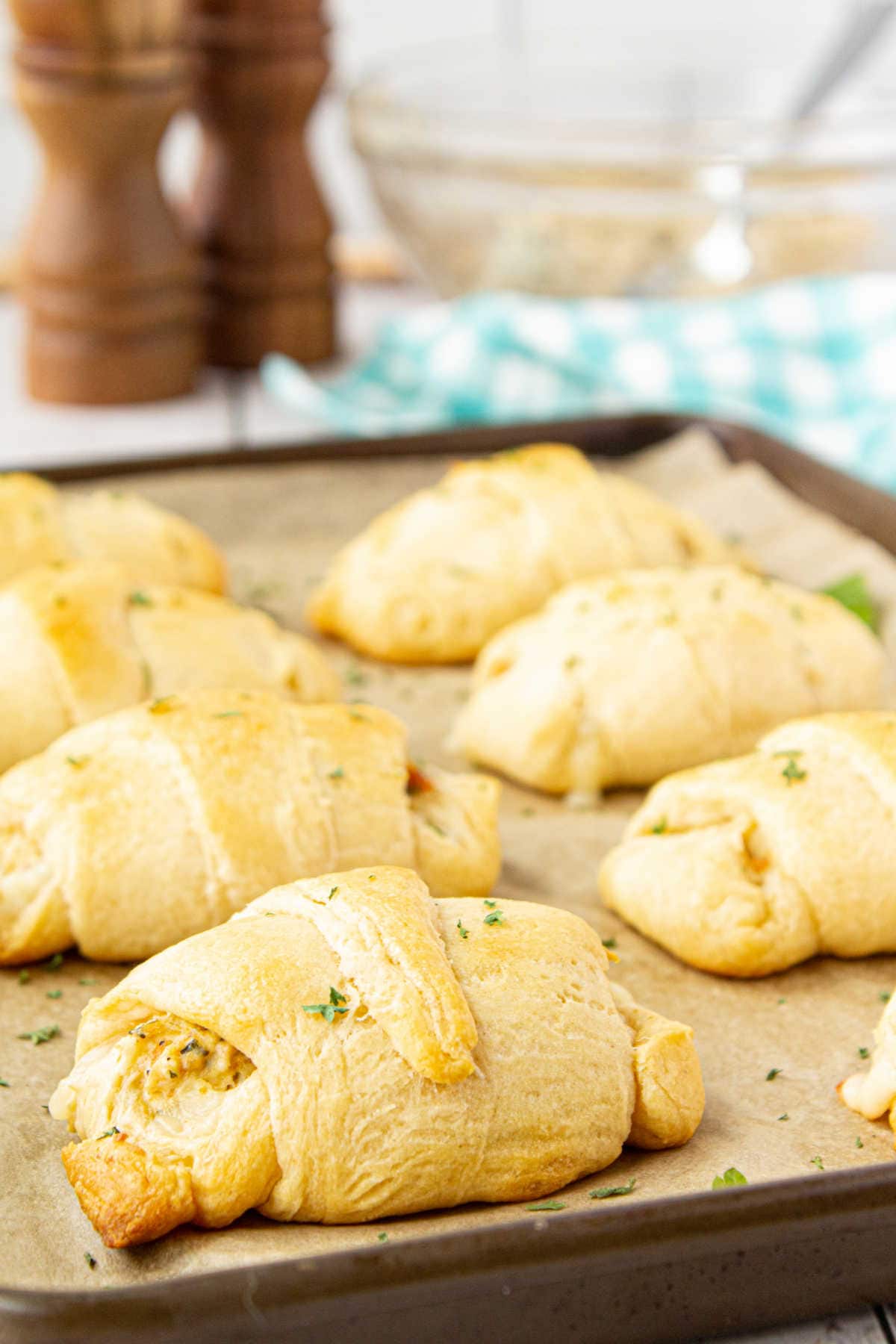 Finished crescent rolls on a baking sheet.