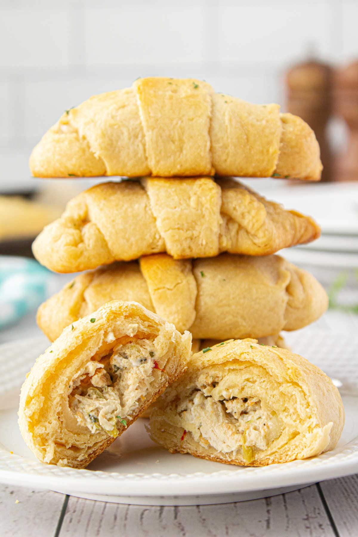 A crescent roll cut in two to show the filling.