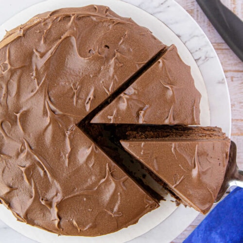 Overhead view of cake being sliced for feature image.