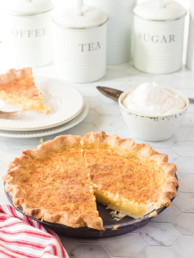 Buttermilk pie with a slice taken out.
