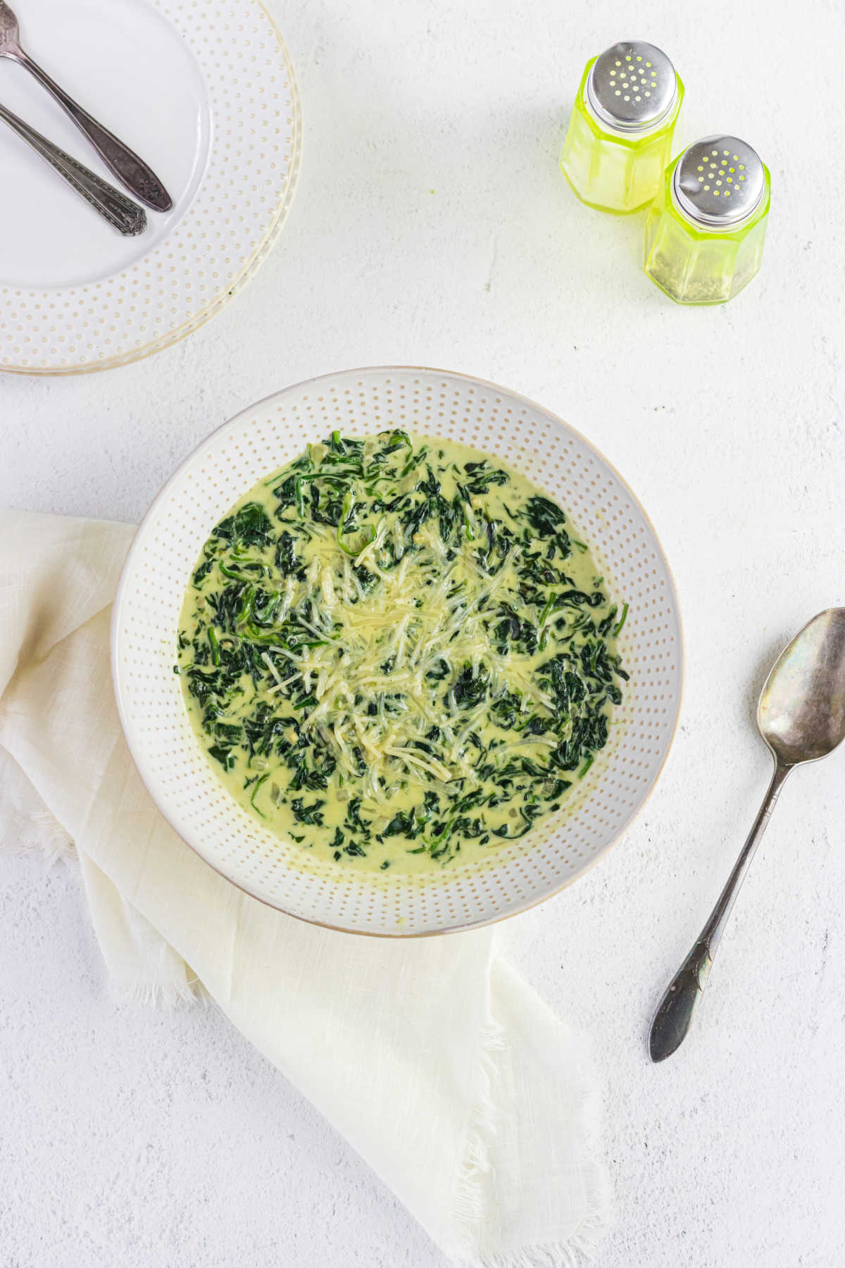 Overhead view of creamed spinach in a serving bowl.