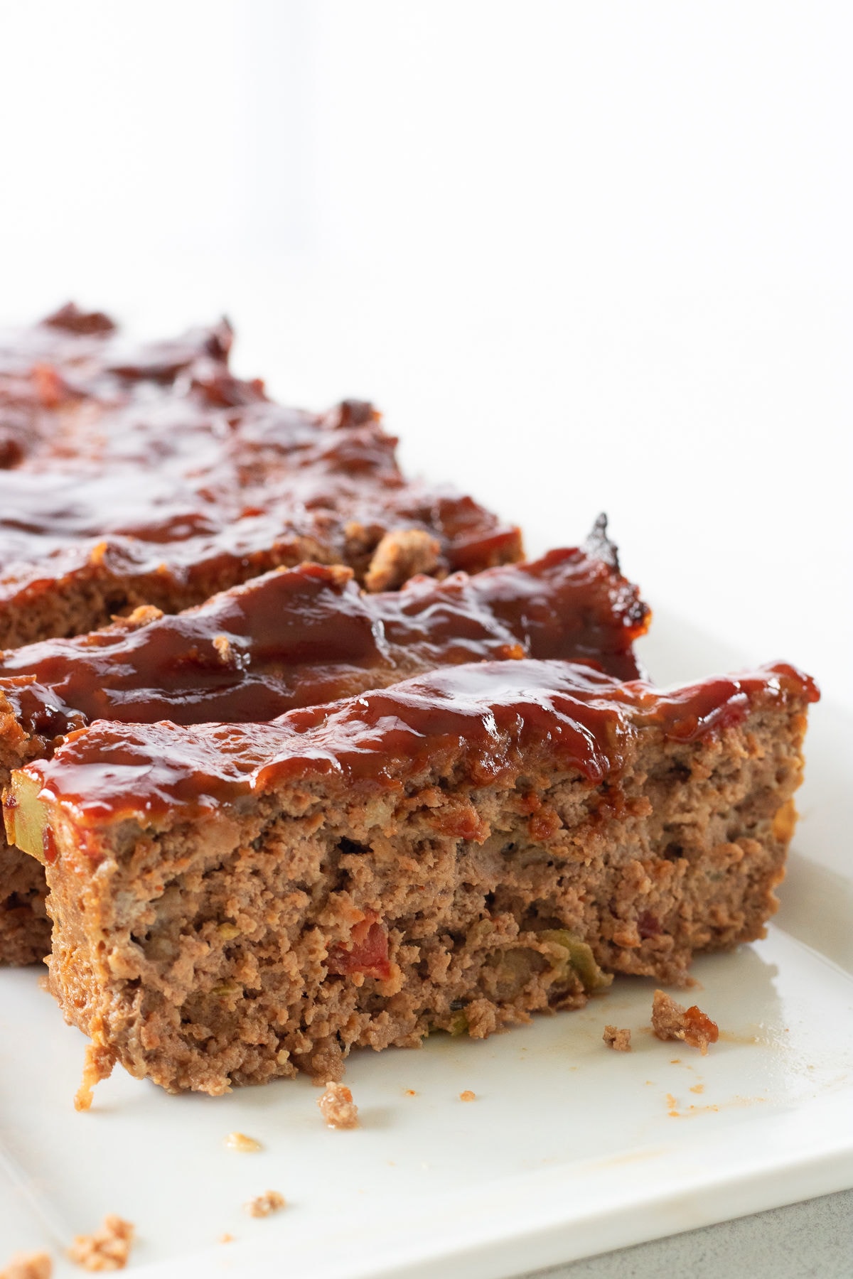 Meatloaf slices on a white plate.