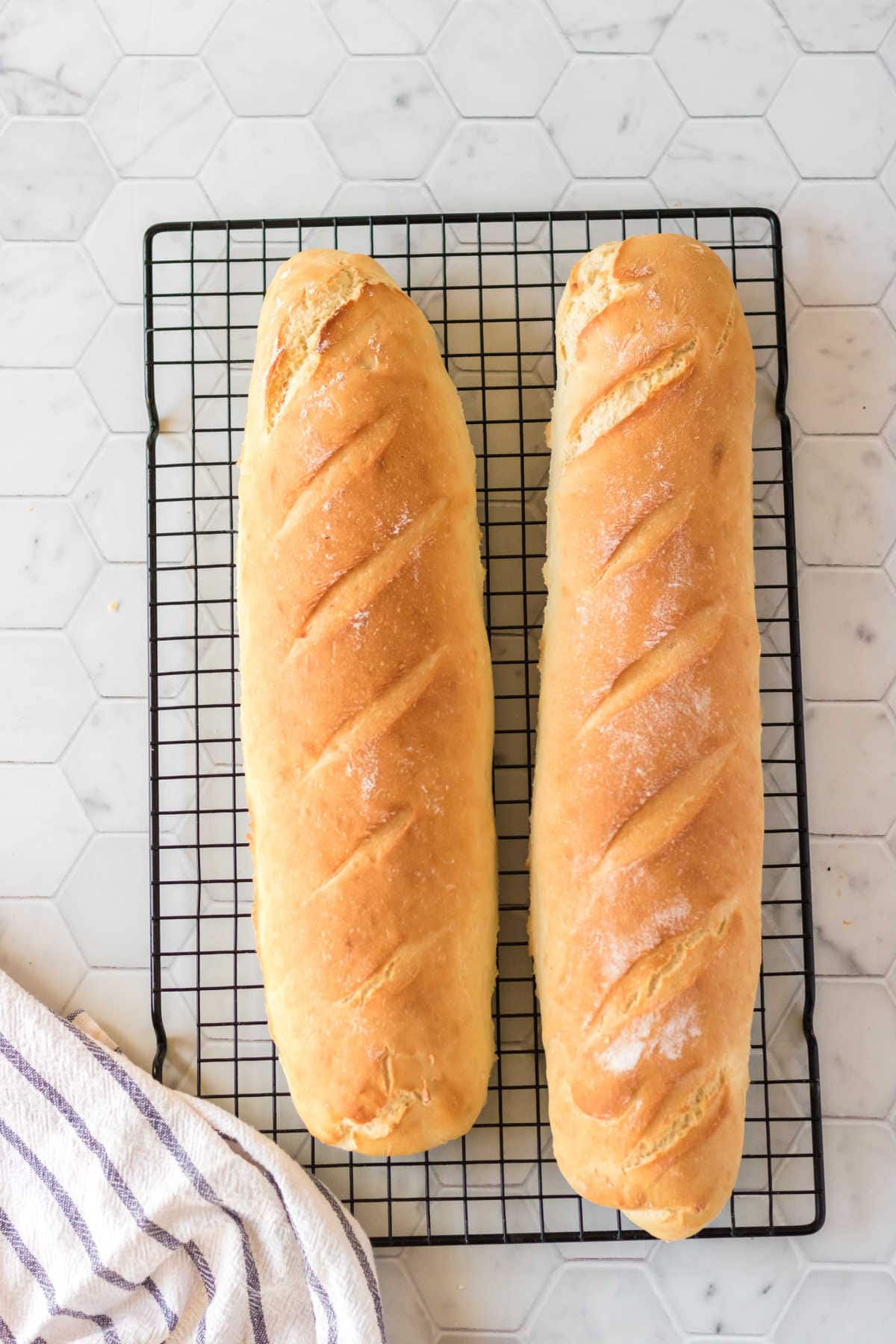 Homemade baguette next to another.