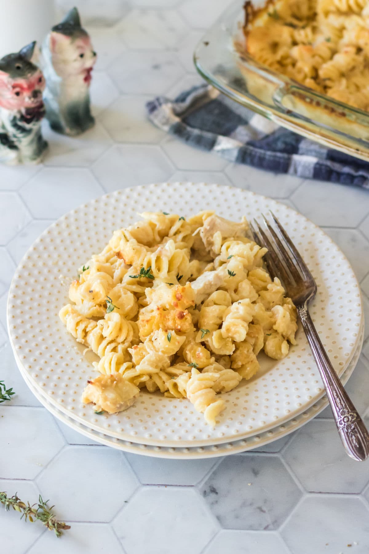 Angel Chicken Mac & Cheese on a white plate with a fork.