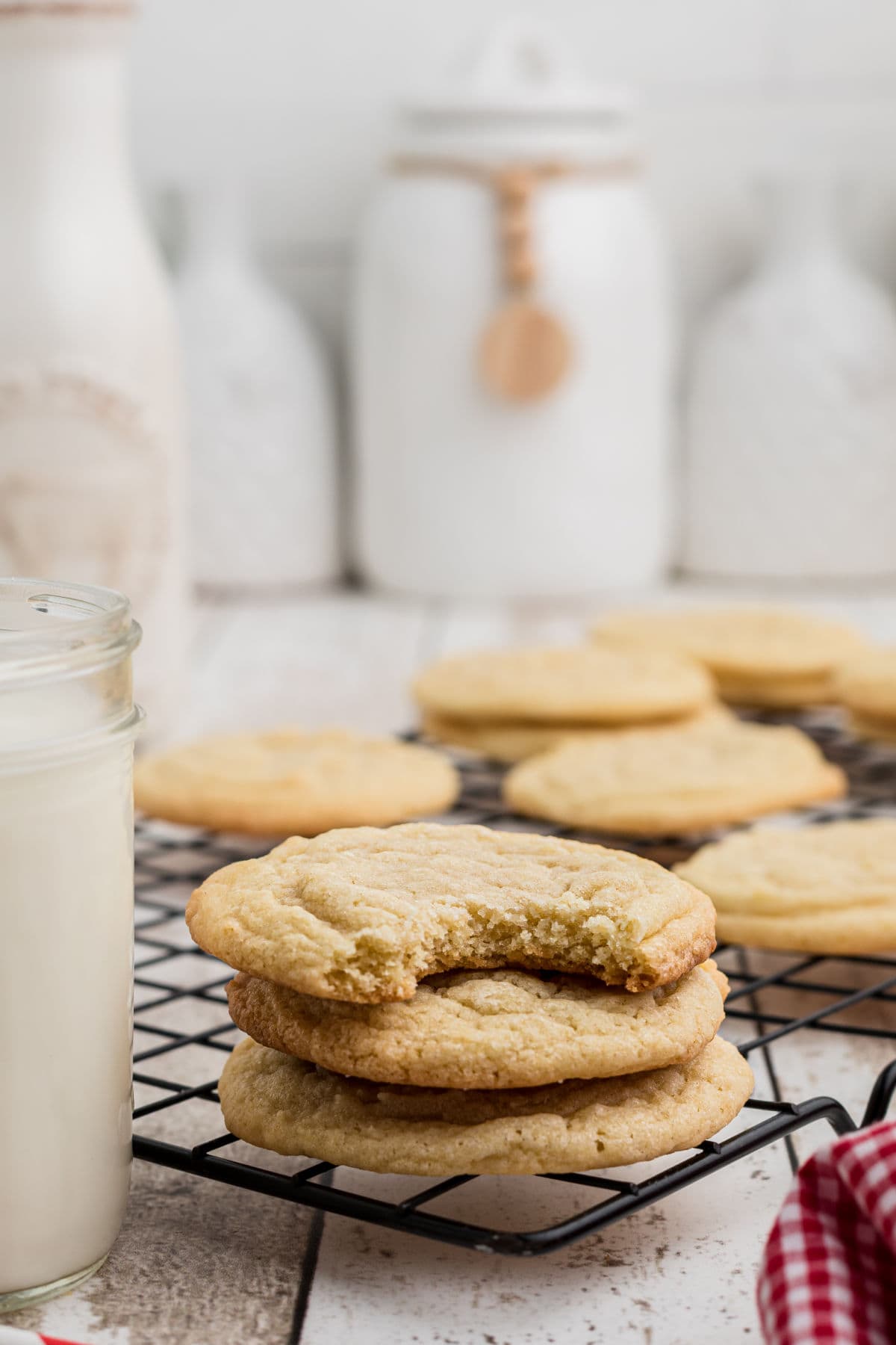 Cookies stacked up on a cooling rack.