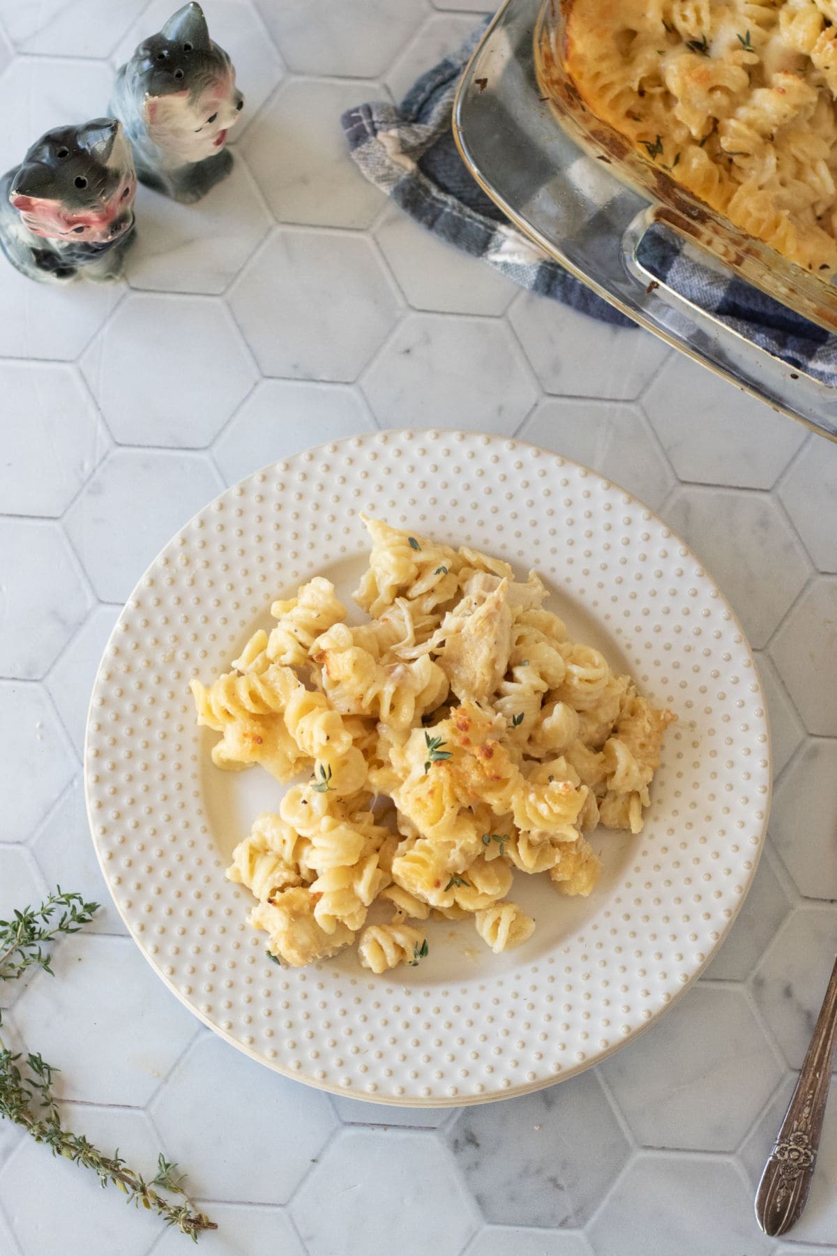 Overhead view of a plate of mac and cheese on a white countertop.