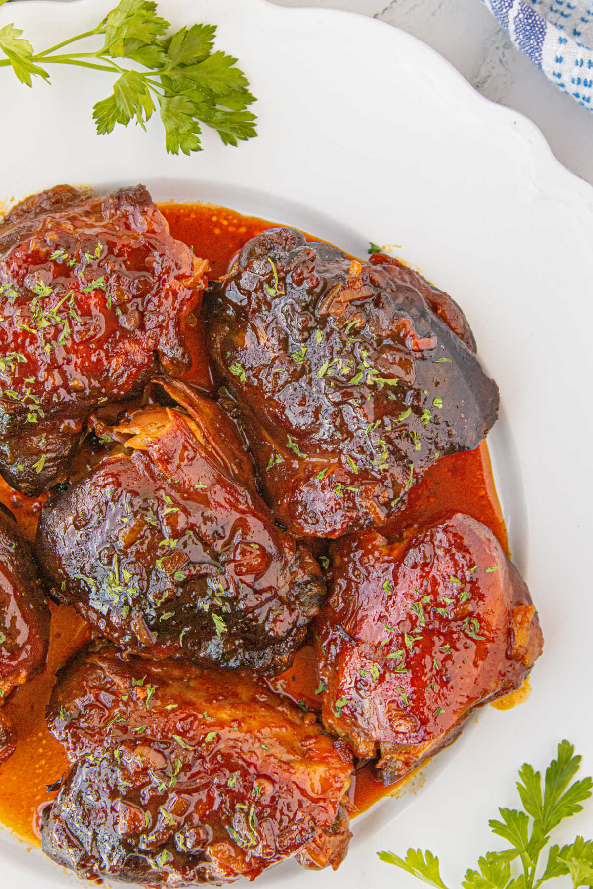 Overhead view of apricot chicken on a white plate.